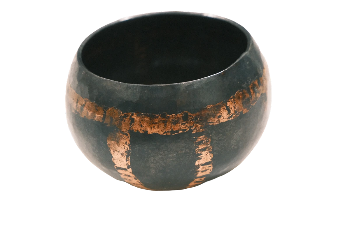 A finished, hand hammered alms bowl