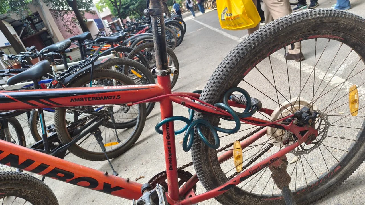 A red cycle with a cable lock passed through the frame alone, attached to nothing
