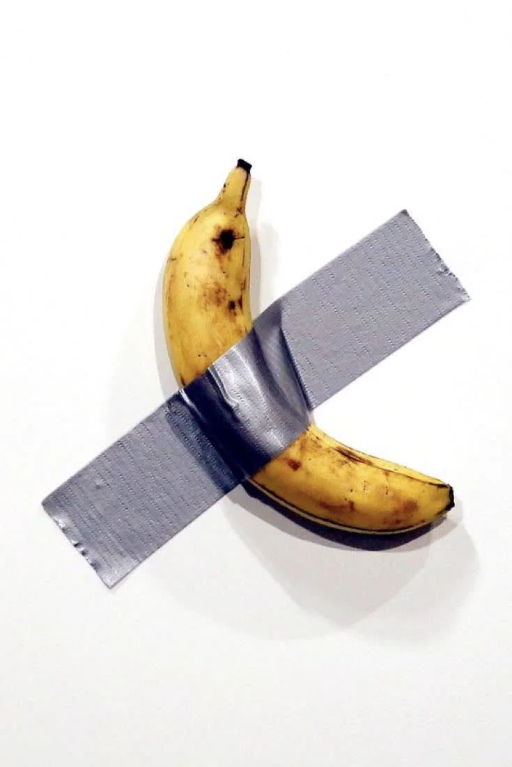 A banana fixed to a wall with tape