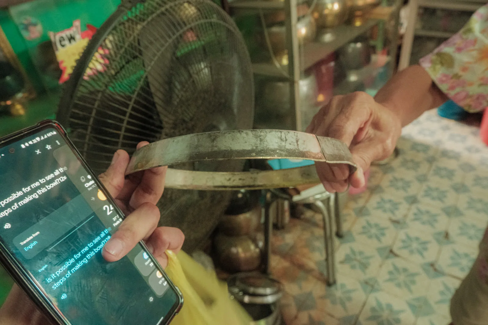 Hands shaping the steel leaves of a bowl