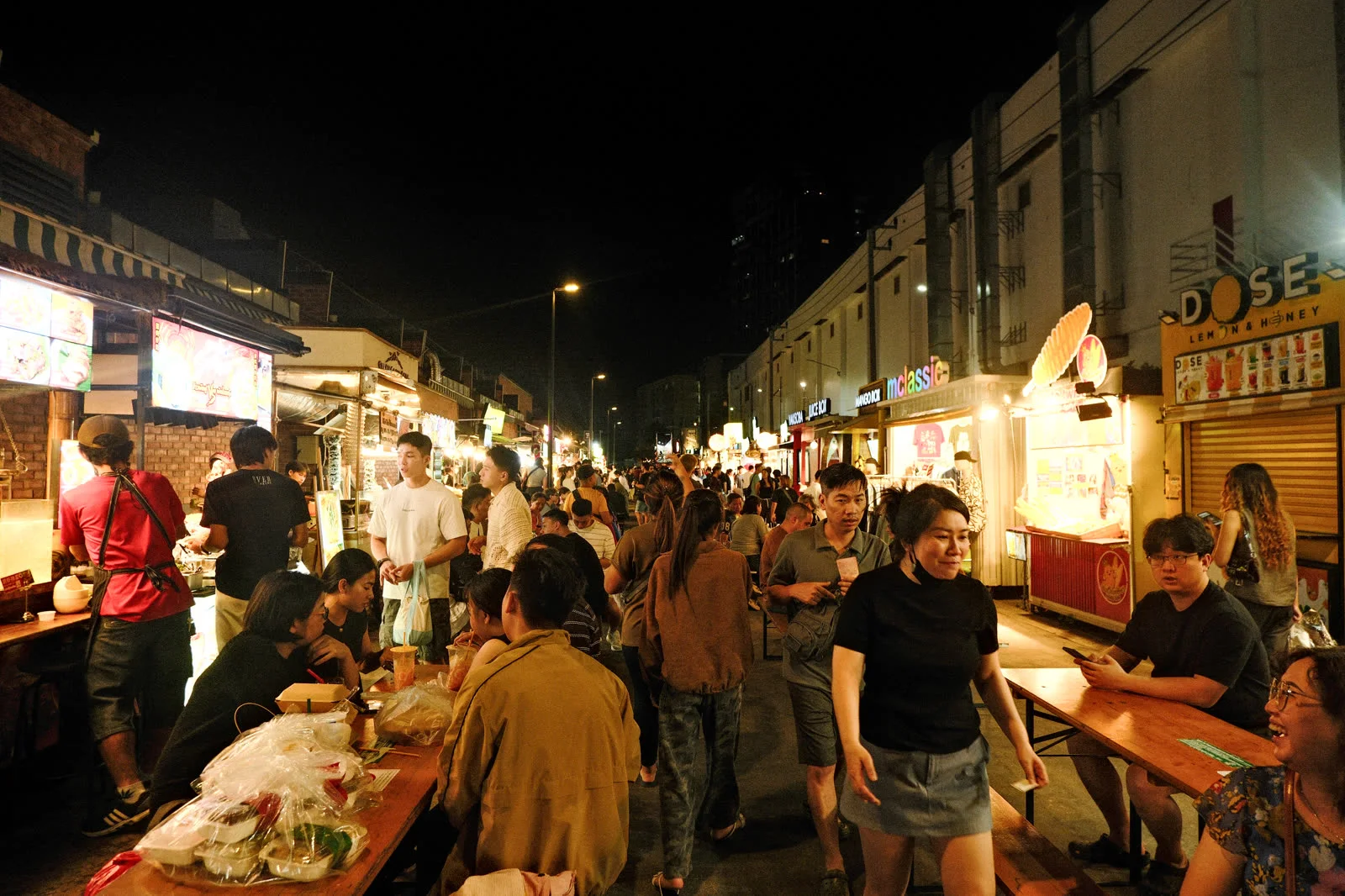 A crowd moving through the night market