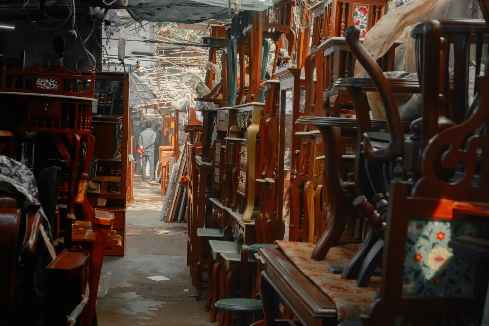 An aisle of furniture stacked into interlocked vertical towers