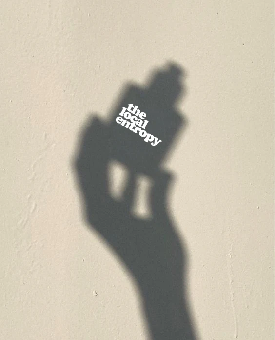 A hand casting a shadow that resolves into the brand wordmark