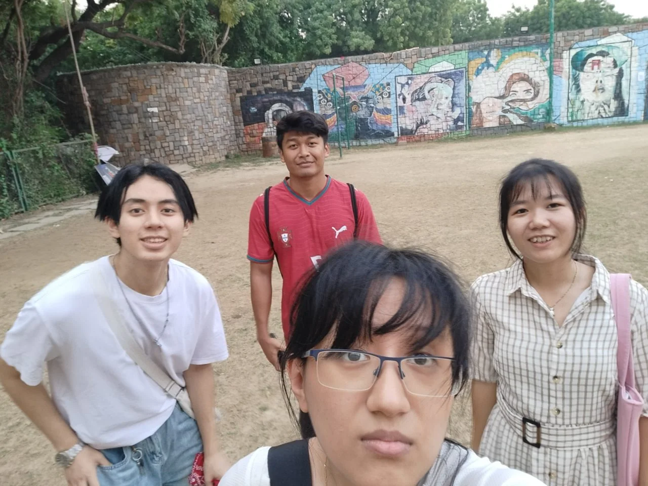 Smoked Pork's selfie on the SAC lawn, in front of a painted wall